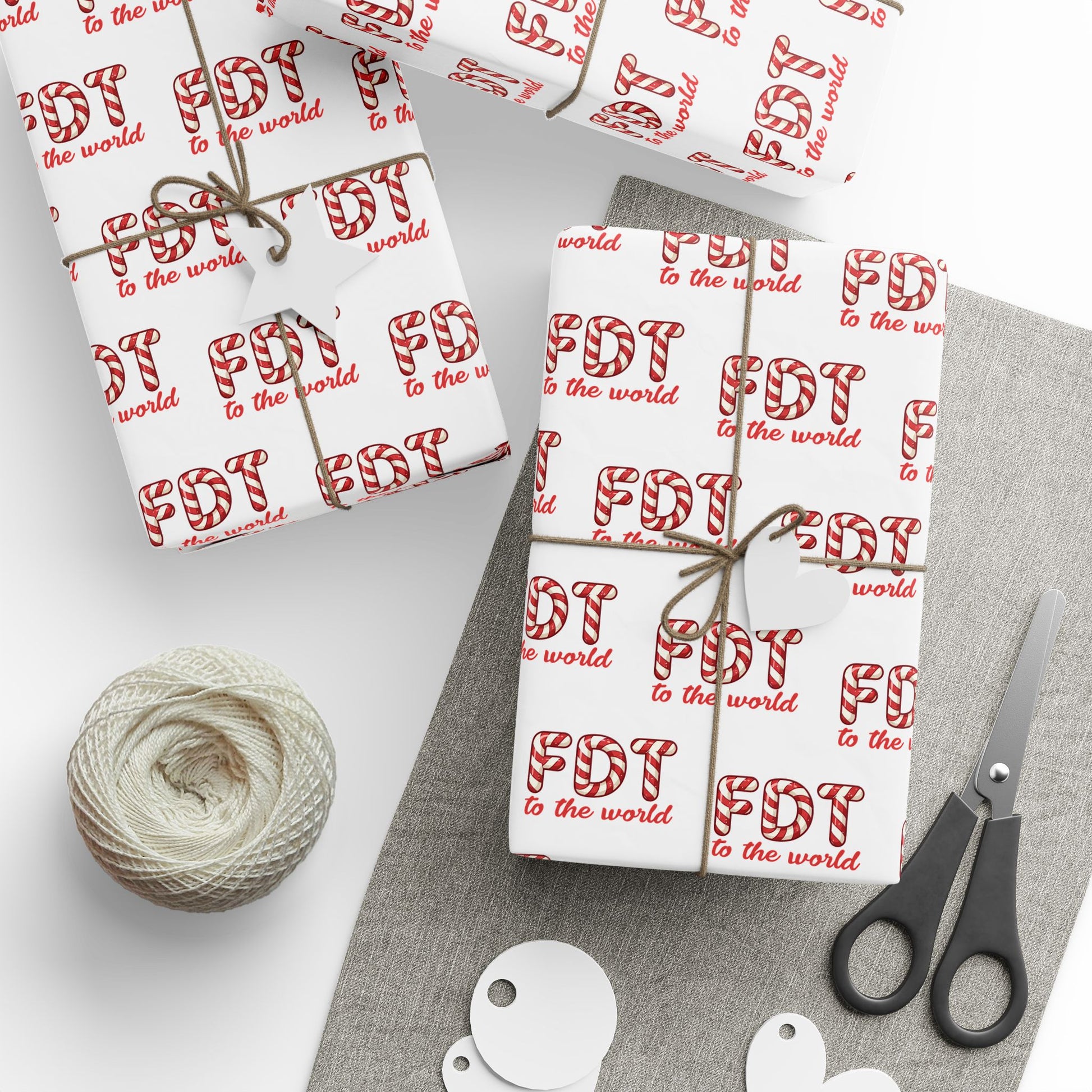 Christmas wrapping paper featuring a repeating pattern of the political text "FDT TO THE WORLD" in a classic red and white candy cane font.